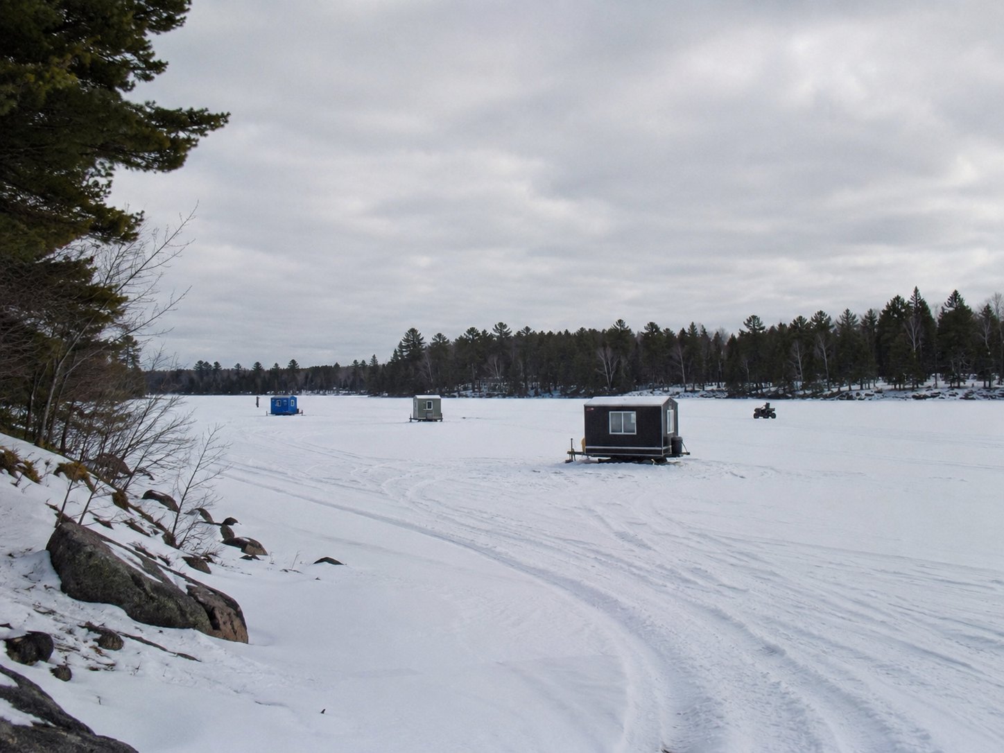 Ice houses settle onto the Chain of Lakes during the part of the year when every road seems to continue onto water.