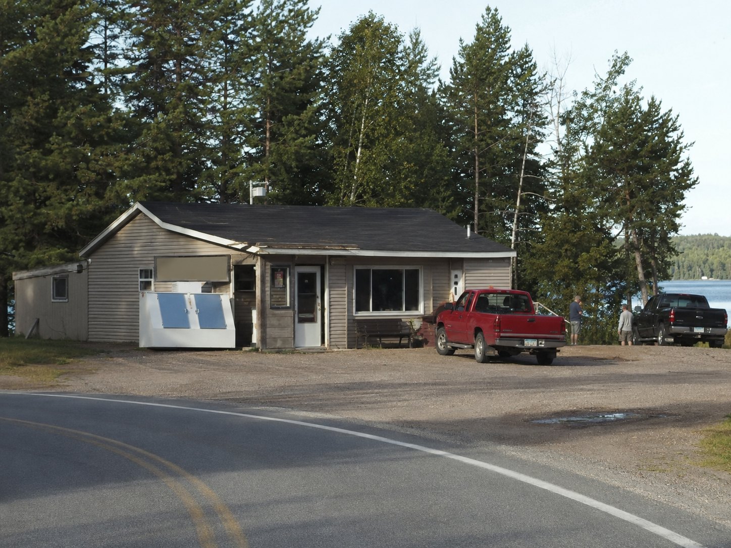 A lakeside storefront on the highway curve, the kind of place where fishing reports become public record.