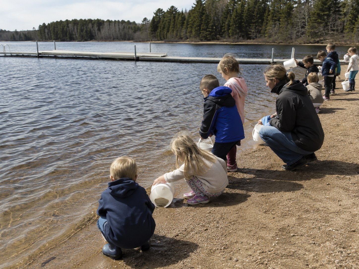 Third graders release trout fingerlings into Big Pelican during the class’s spring field trip.
